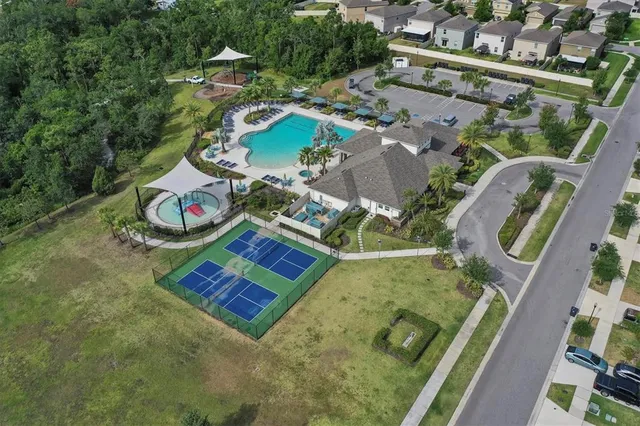 an aerial view of a house with swimming pool and outdoor space