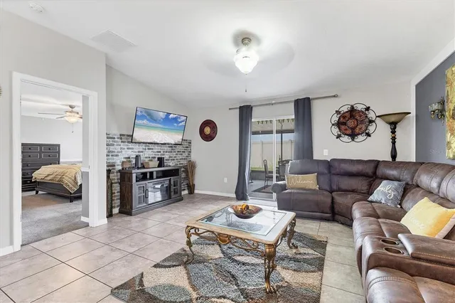 a living room with furniture and a view of kitchen