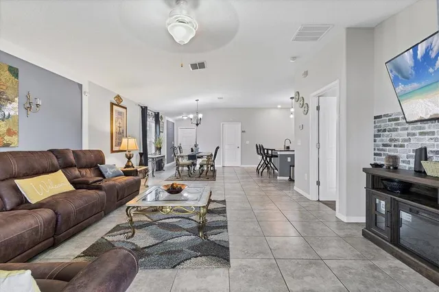 a living room with furniture a dining table and a stove top oven