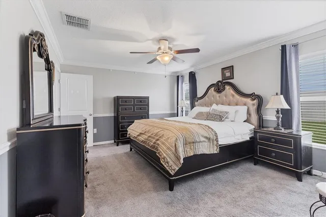 a bedroom with a bed dresser and a window