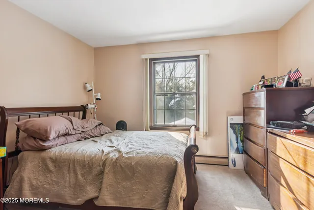 a bedroom with a bed and a book shelf