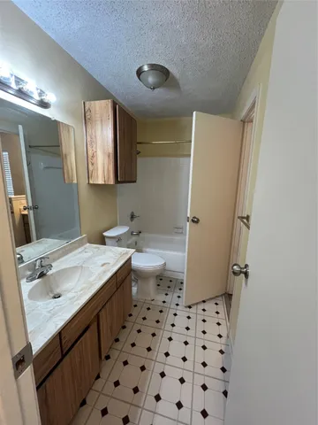a bathroom with a sink a toilet a shower a and mirror