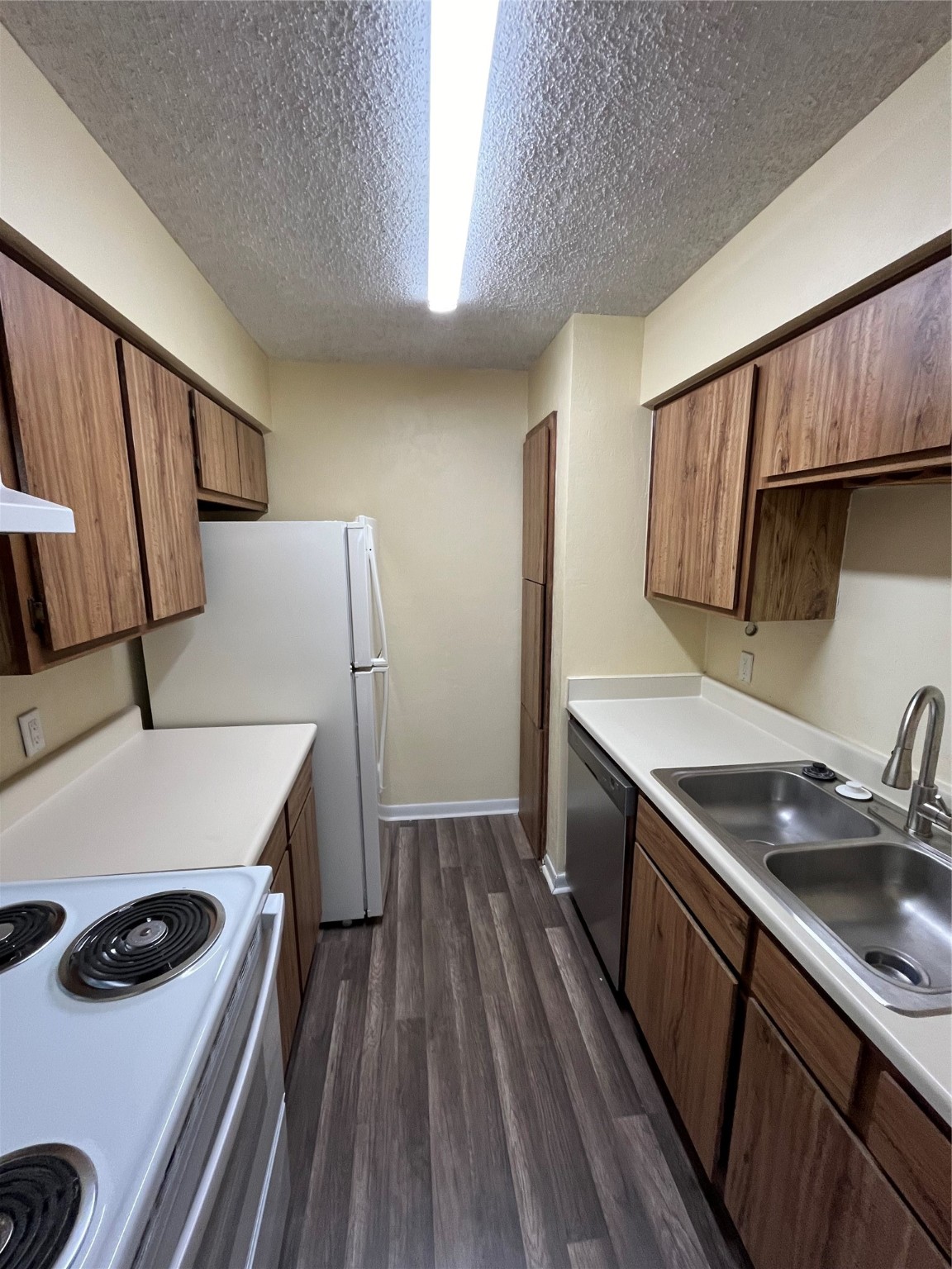 3919 Fairmont Parkway, Unit 200 Pasadena, TX 77504 - Photo 4 of 13 a kitchen with a sink a stove and refrigerator