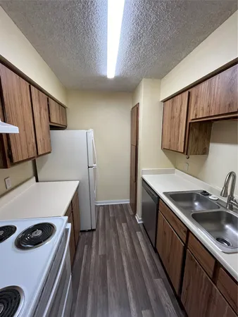 a kitchen with a sink a stove and refrigerator