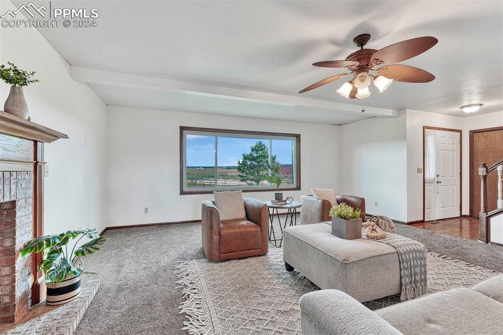 12220 Old Barn Road Elbert, CO 80106 - Photo 13 of 47 a living room with furniture a window and a chandelier