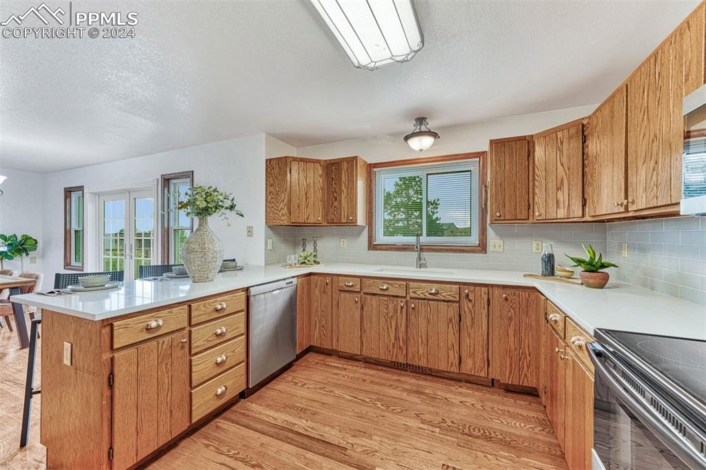 12220 Old Barn Road Elbert, CO 80106 - Photo 15 of 47 a kitchen with kitchen island granite countertop a sink window and cabinets