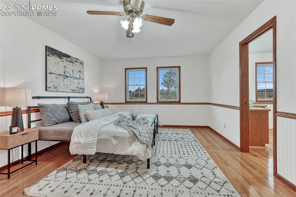 12220 Old Barn Road Elbert, CO 80106 - Photo 19 of 47 a bedroom with a large bed and a couch