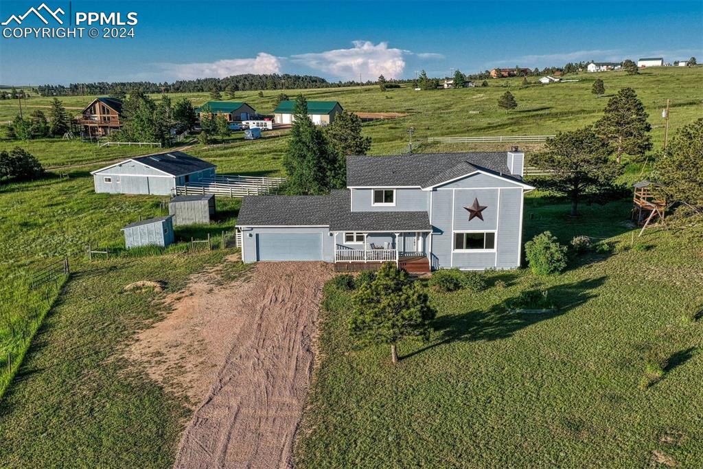 12220 Old Barn Road Elbert, CO 80106 - Photo 2 of 47 an aerial view of a house with a garden