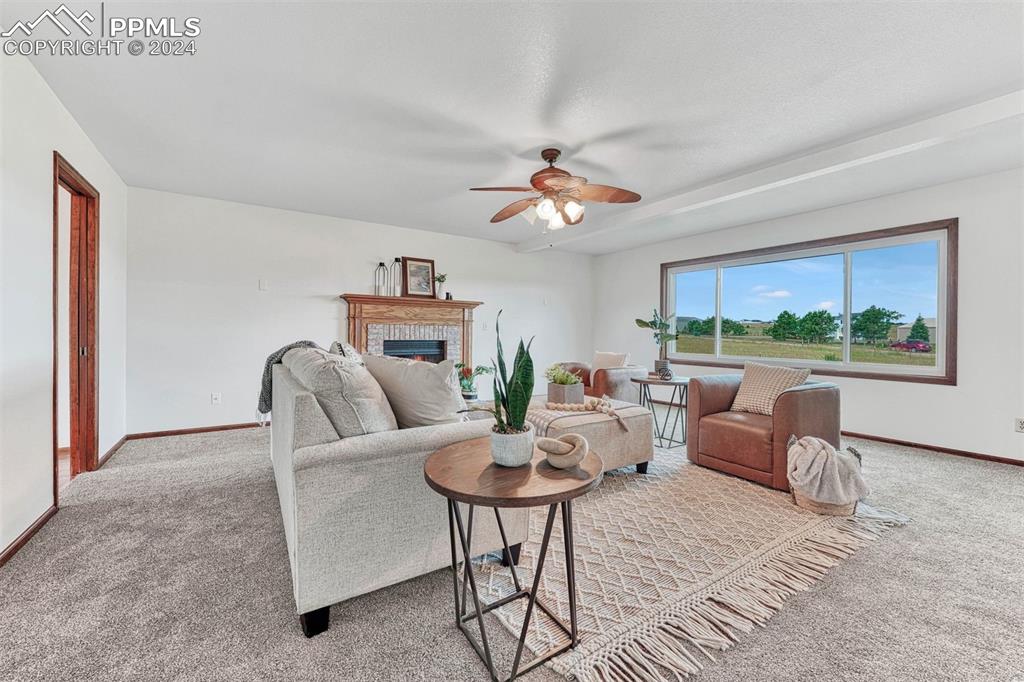 12220 Old Barn Road Elbert, CO 80106 - Photo 24 of 47 a living room with furniture a table and a large window