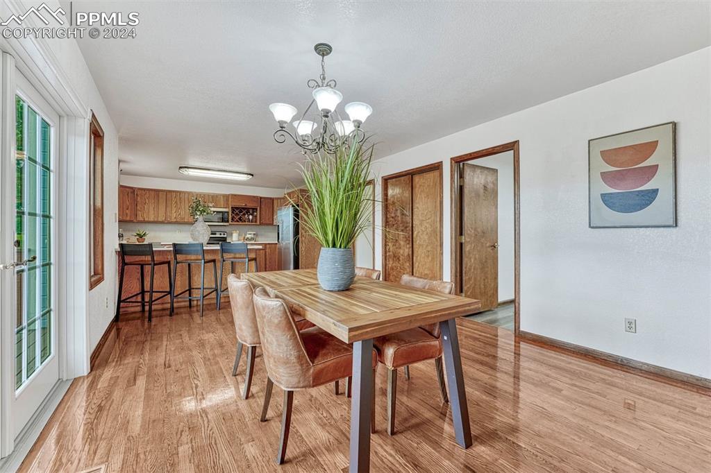 12220 Old Barn Road Elbert, CO 80106 - Photo 28 of 47 a view of a dining room with furniture wooden floor and chandelier