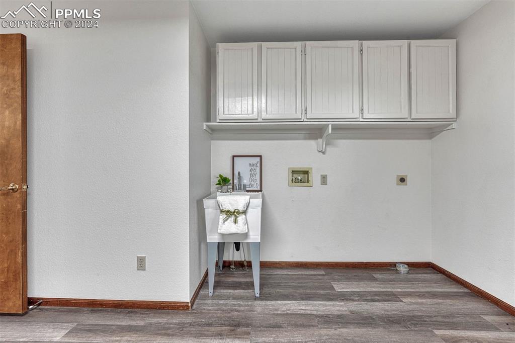 12220 Old Barn Road Elbert, CO 80106 - Photo 29 of 47 a view of an empty room with wooden floor and cabinet