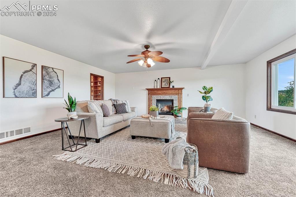 12220 Old Barn Road Elbert, CO 80106 - Photo 3 of 47 a living room with furniture a fireplace and a window