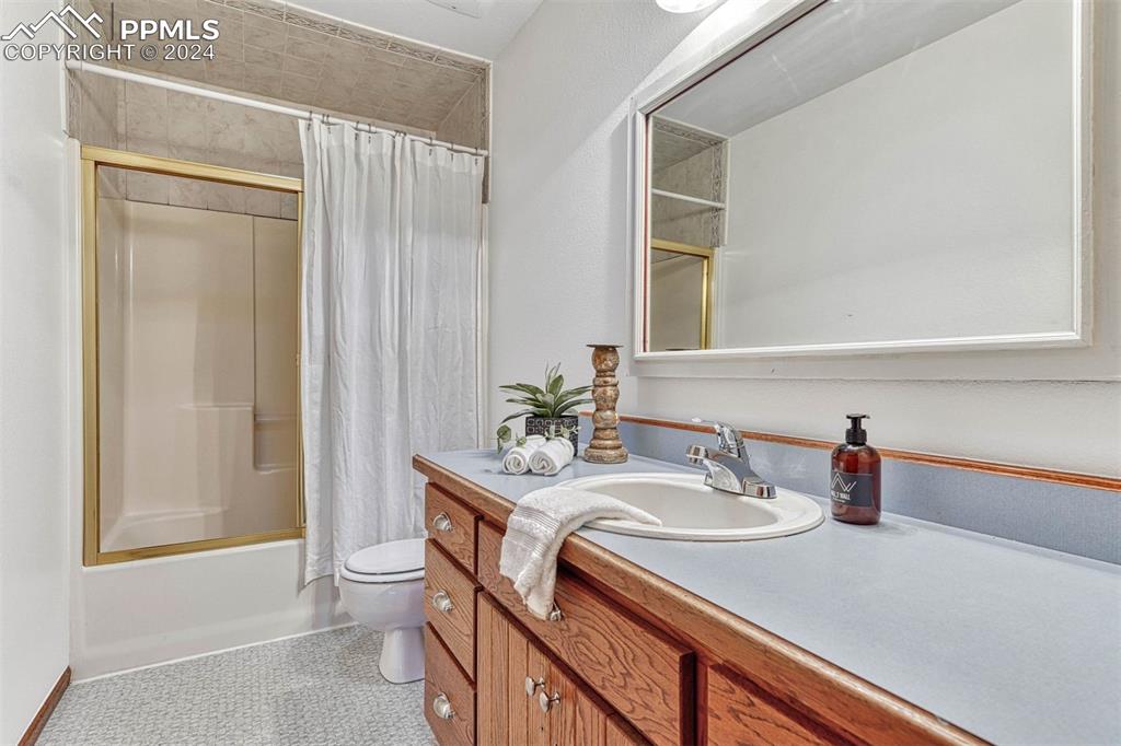 12220 Old Barn Road Elbert, CO 80106 - Photo 33 of 47 a bathroom with a sink toilet and shower