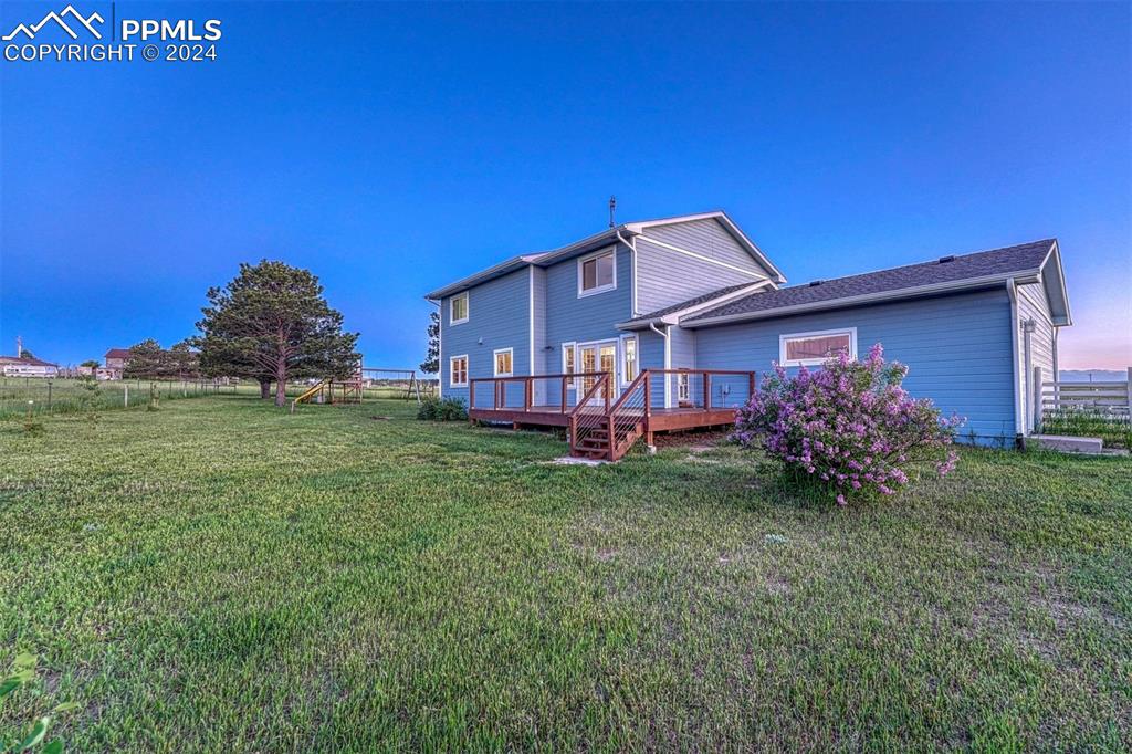 12220 Old Barn Road Elbert, CO 80106 - Photo 42 of 47 a view of a house with a big yard potted plants and large tree