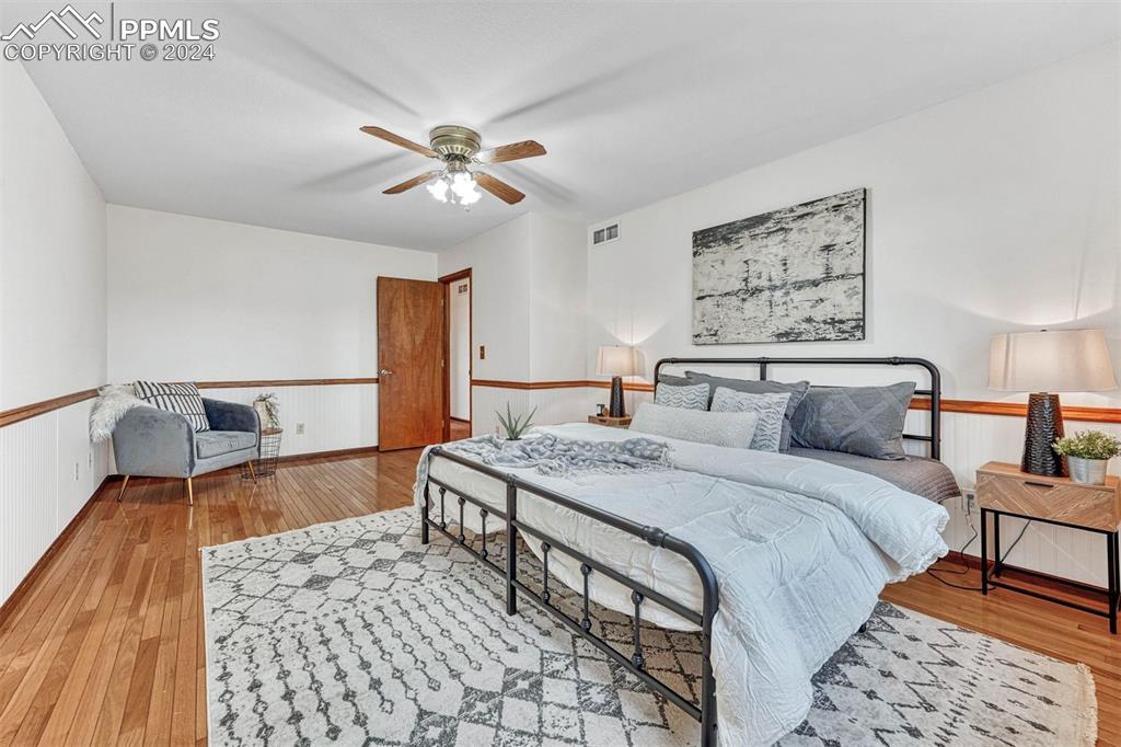 12220 Old Barn Road Elbert, CO 80106 - Photo 6 of 47 a bedroom with a bed and a chandelier