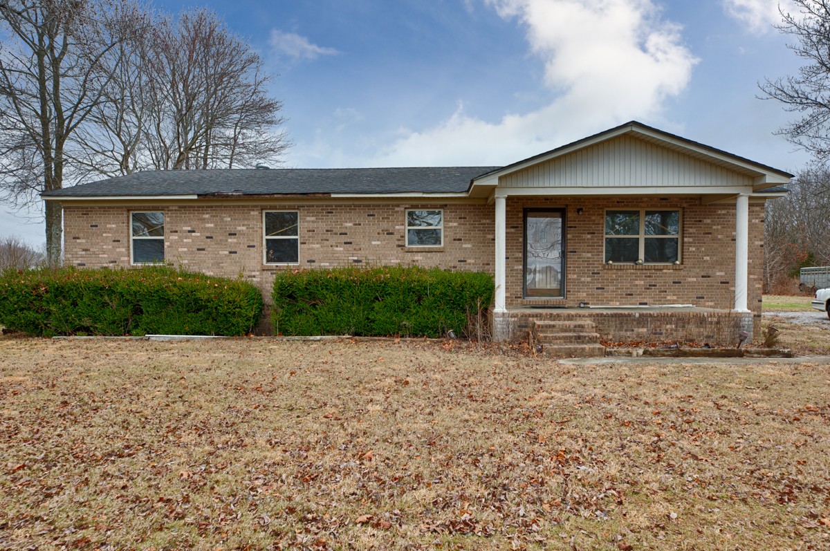 236 Old Baptist Road Ardmore, TN 38449 - Photo 1 of 15 a front view of a house with a yard