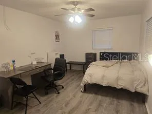 a bedroom with a bed and a desk