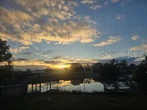 a living room with a couch a flat screen tv and a large window