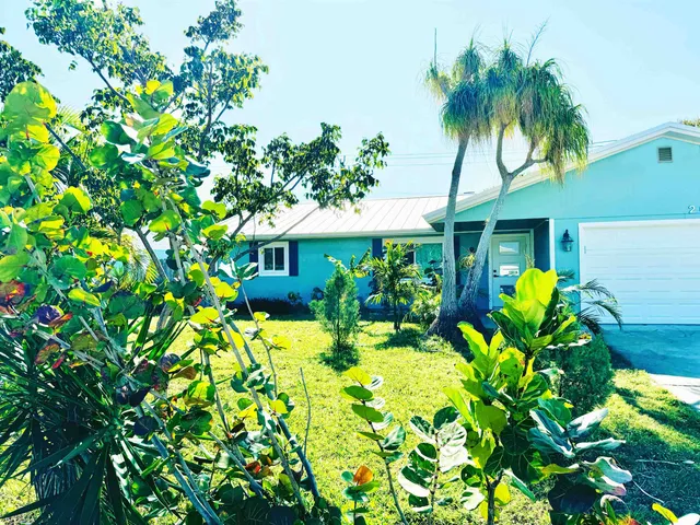 a view of a house with a flower garden