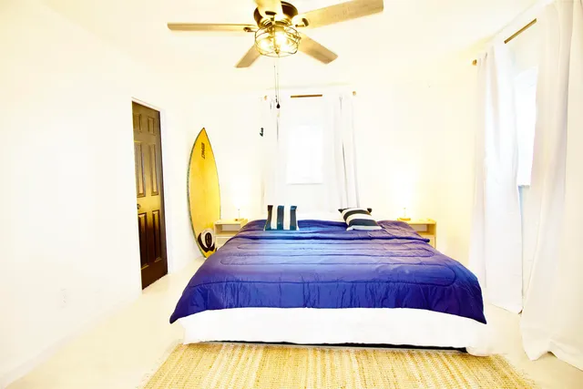 a living room with a bed furniture and a window