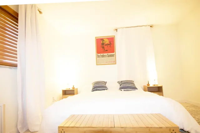 a bedroom with a bed and a painting on the wall