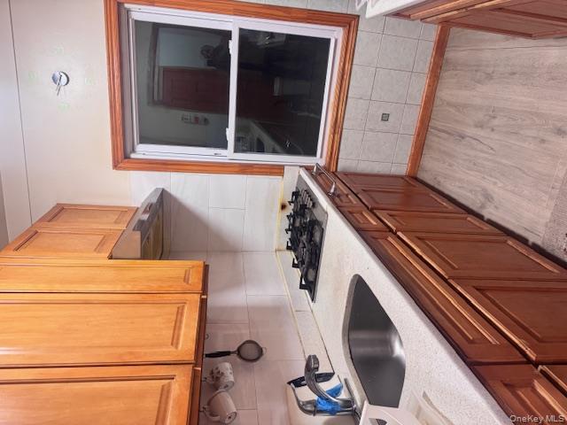 91-33 78th Street Queens, NY 11421 - Photo 11 of 26 a kitchen with a sink and cabinets