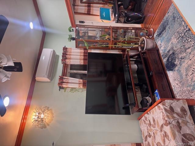 91-33 78th Street Queens, NY 11421 - Photo 4 of 26 a bedroom with furniture and a flat screen tv