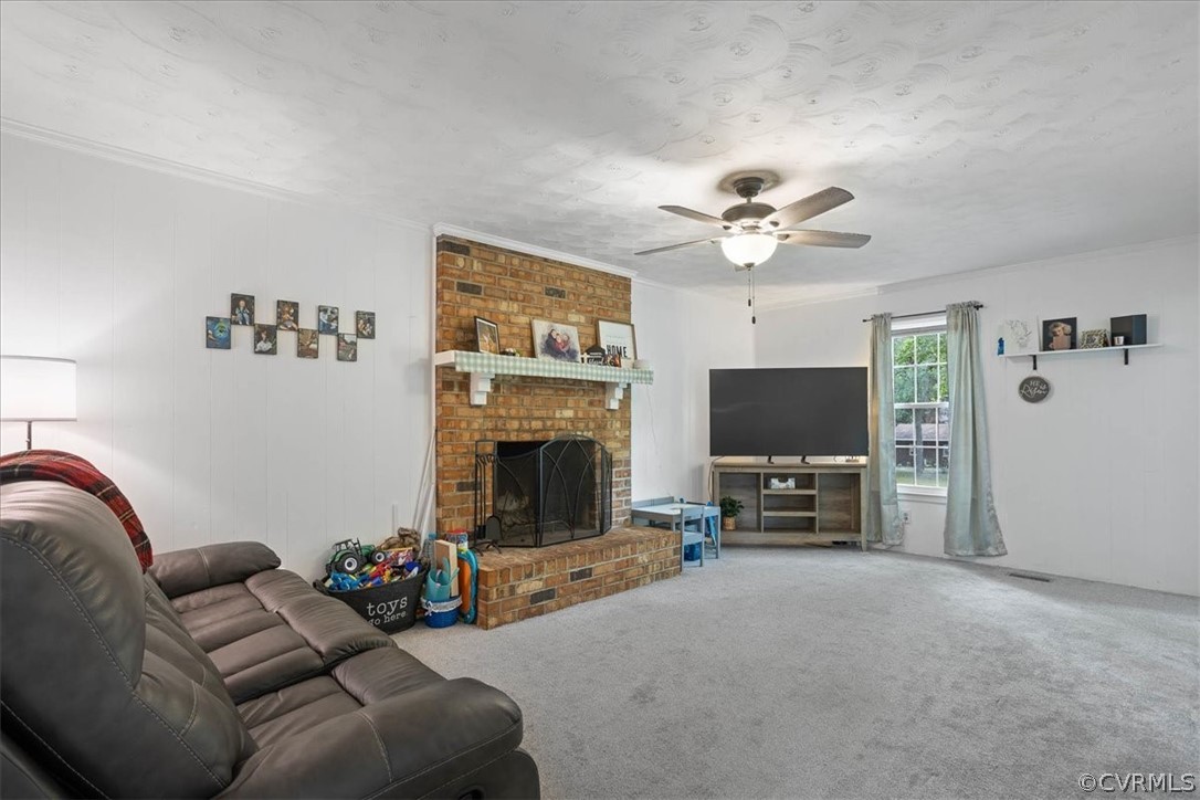16127 Sandwave Road Chester, VA 23831 - Photo 10 of 26 a living room with furniture a flat screen tv and a fireplace