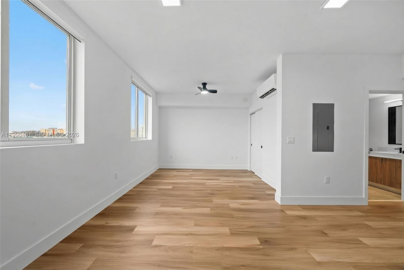 650 Southwest 1st Street, Unit 401 Miami, FL 33130 - Photo 6 of 17 a view of an empty room with window and wooden floor