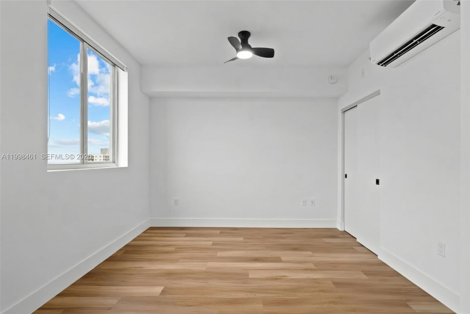 650 Southwest 1st Street, Unit 401 Miami, FL 33130 - Photo 7 of 17 a view of empty room with wooden floor and fan