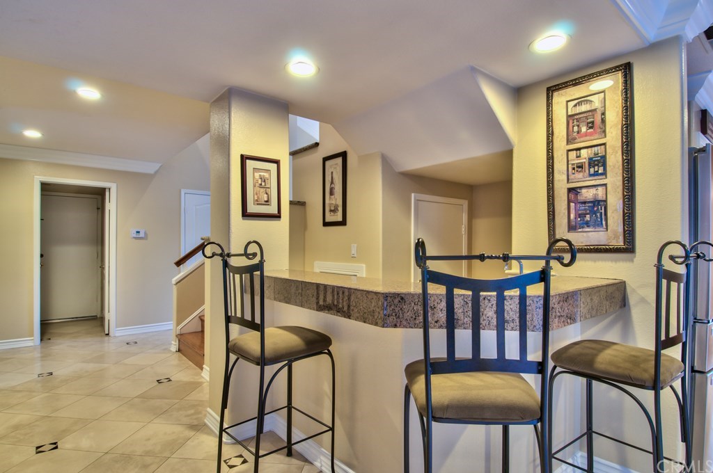 4224 San Ramon Drive Corona, CA 92882 - Photo 15 of 63 The full bar is open to the family room and the kitchen and has Granite counter tops and a wine cooler.