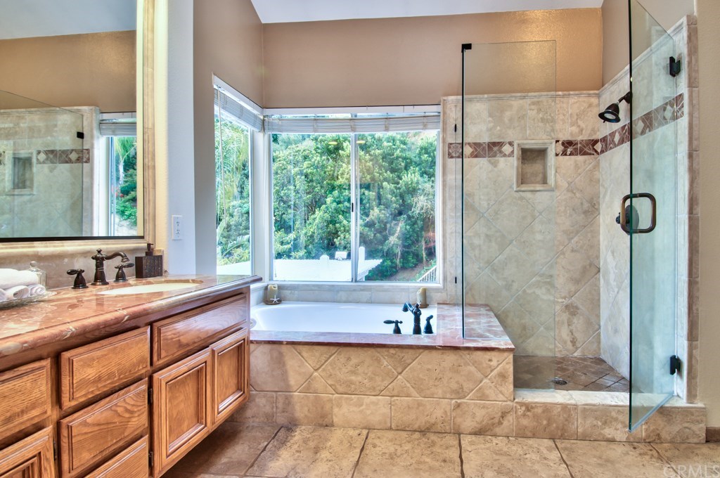 4224 San Ramon Drive Corona, CA 92882 - Photo 28 of 63 The luxurious master bath has a separate tub and shower with extensive use of Travertine and Marble stones and a thick shower walls.