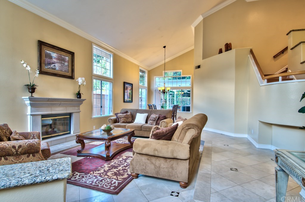 4224 San Ramon Drive Corona, CA 92882 - Photo 63 of 63 Photo of the living and dining room areas. Experience the luxury of grand two-story ceilings, along with an open staircase and a truly exceptional floor plan that boasts a downstairs bedroom with a full bath.