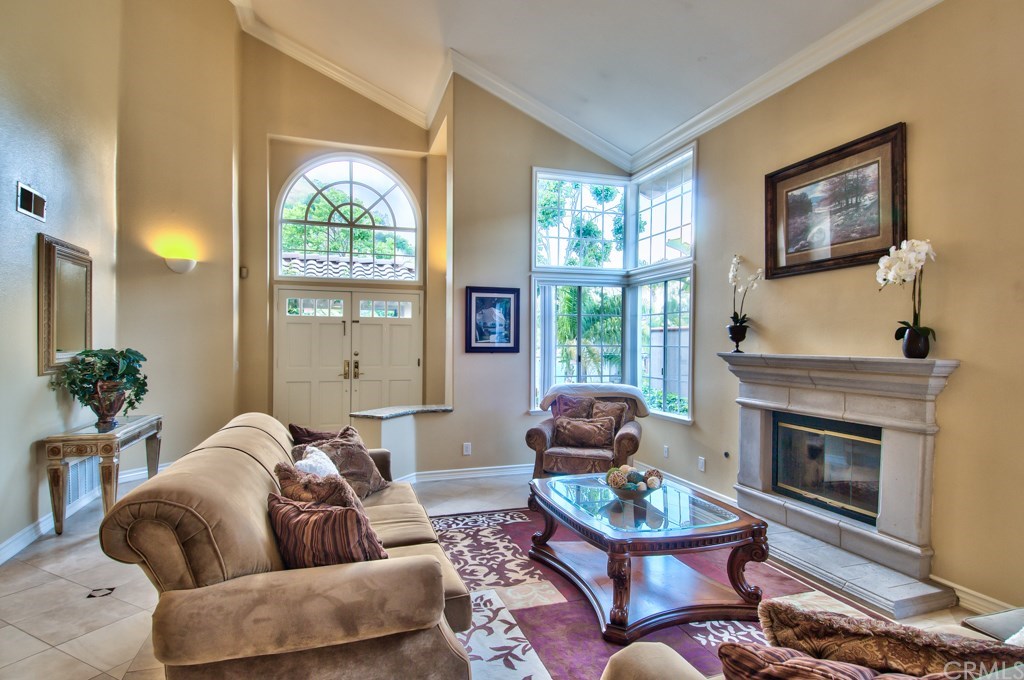 4224 San Ramon Drive Corona, CA 92882 - Photo 8 of 63 Photo of the living room area. This fine home boasts crown moldings everywhere, wood laminate flooring upstairs and diagonally laid limestone flooring with marble inlays throughout the first floor.