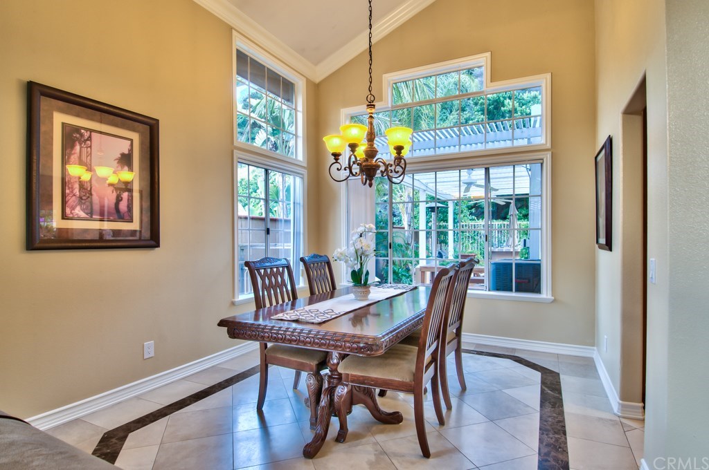 4224 San Ramon Drive Corona, CA 92882 - Photo 9 of 63 Views of the formal dining featuring an updated chandelier, and stacked windows that allow for lots of natural light to infiltrate these living areas.