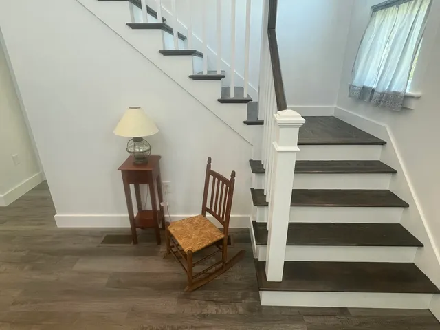 a view of entryway and hall with wooden floor