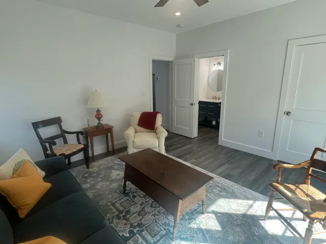 a living room with furniture and wooden floor