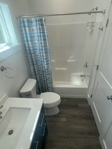 a bathroom with a toilet and shower