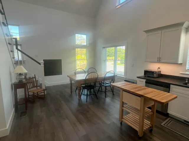 a open dining room with furniture window and wooden floor