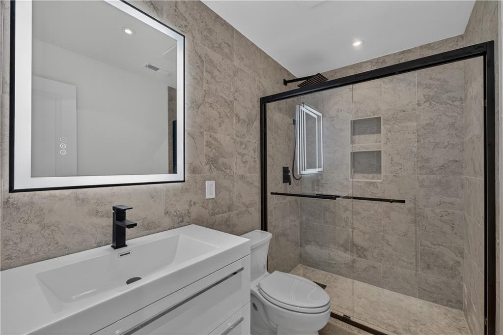 4610 West Morton Road Alpharetta, GA 30022 - Photo 41 of 53 a bathroom with a sink mirror and a toilet