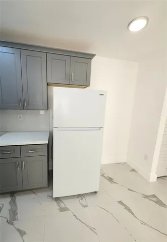 a white refrigerator freezer sitting in a kitchen
