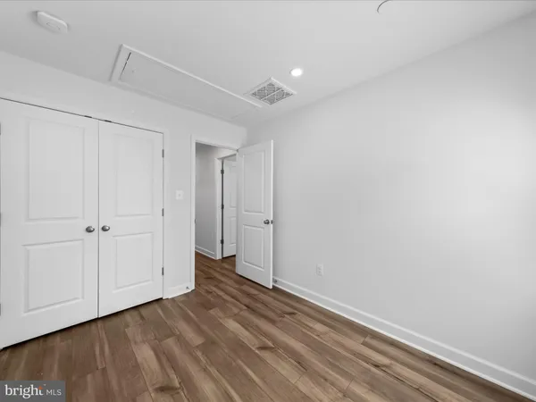 a view of room with wooden floor and white walls