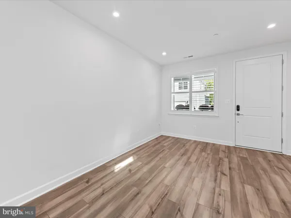 a large kitchen with kitchen island a sink stainless steel appliances and cabinets