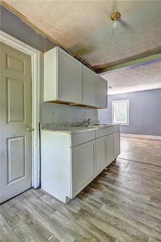 a view of a kitchen with wooden floor