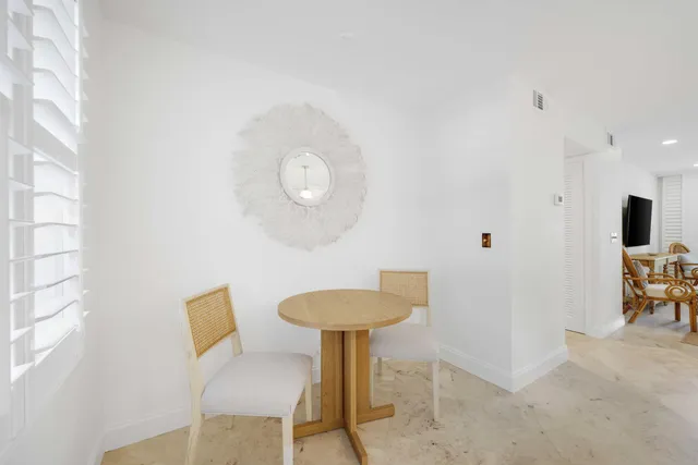 a view of a room with a table and chairs