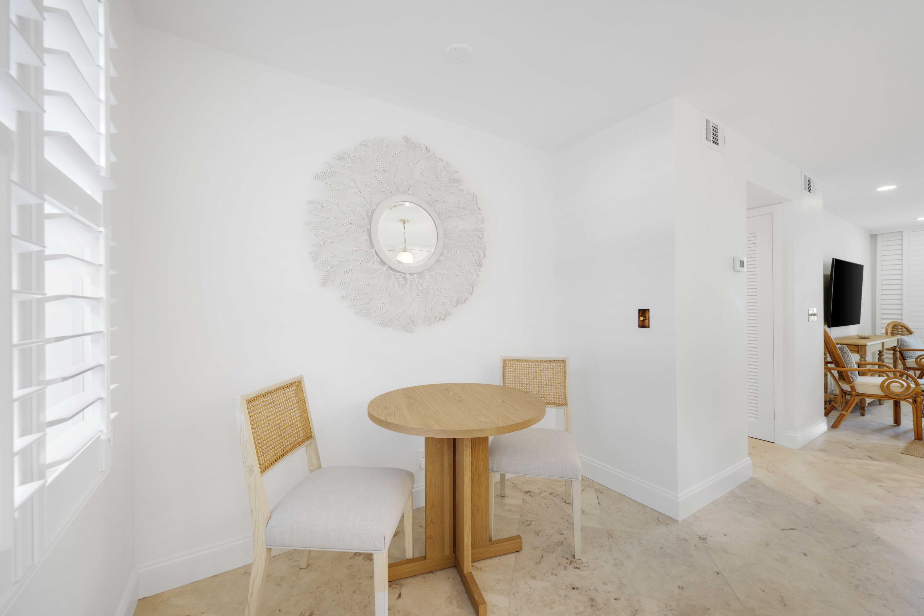 139 Sunrise Avenue, Unit 1040 Palm Beach, FL 33480 - Photo 14 of 43 a view of a room with a table and chairs