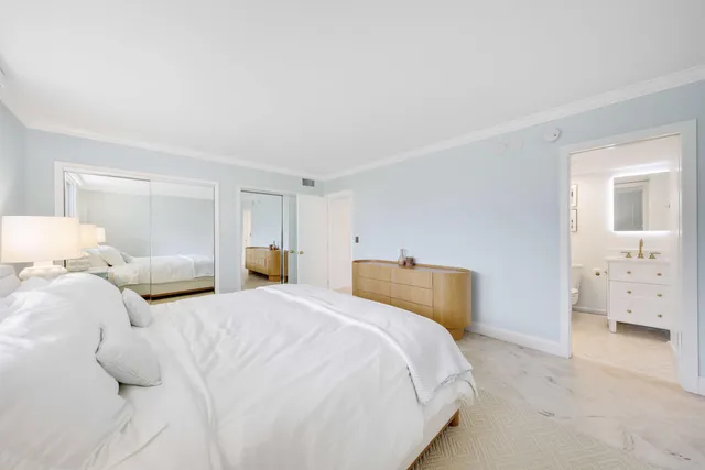 a bedroom with a bed and a walk in closet