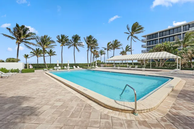 a swimming pool with outdoor seating and yard