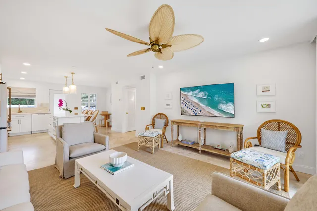 a living room with furniture and a dining table