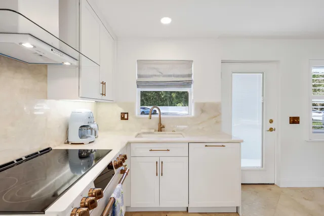 a kitchen with a sink stove and cabinets